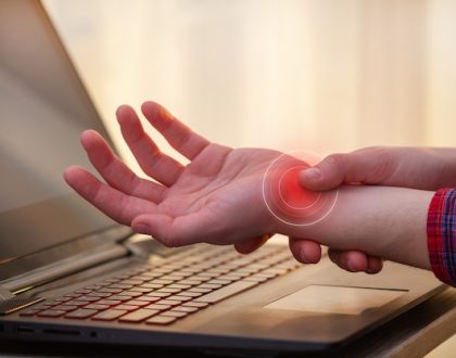 How can touch typing help with carpal tunnel syndrome?